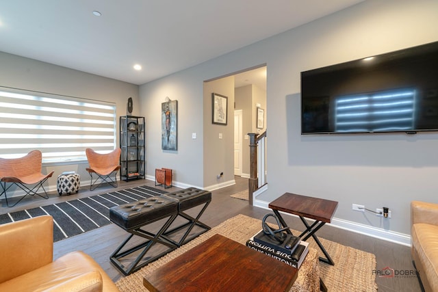 living area with recessed lighting, baseboards, and wood finished floors