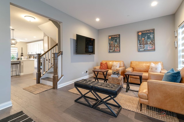 living area with dark wood-style floors, stairway, recessed lighting, and baseboards