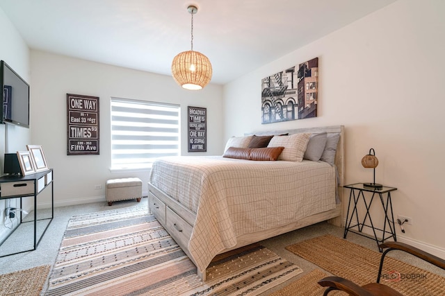 carpeted bedroom featuring baseboards