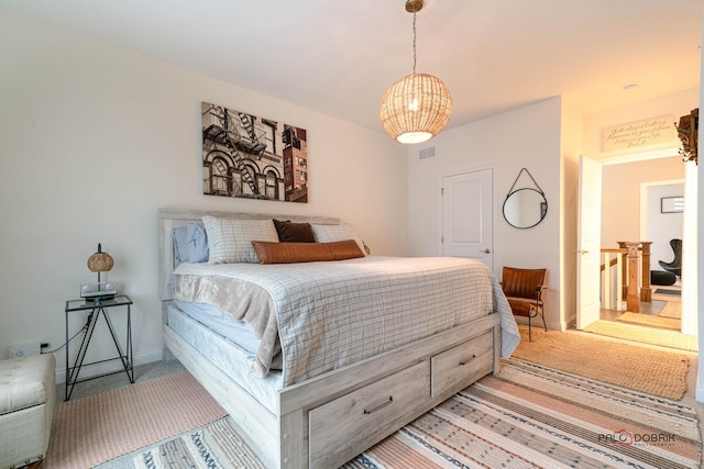 carpeted bedroom with visible vents and baseboards