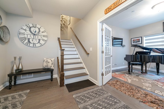 interior space featuring baseboards and wood finished floors