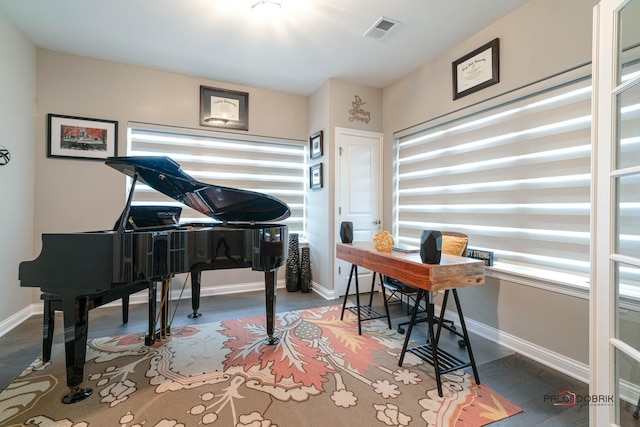 office with visible vents, baseboards, and wood finished floors