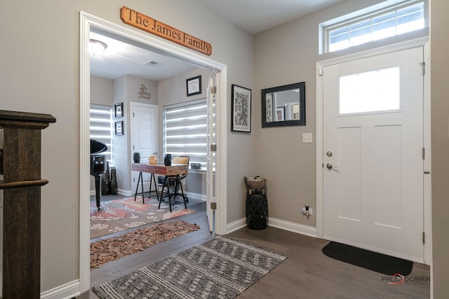 entryway featuring baseboards and wood finished floors