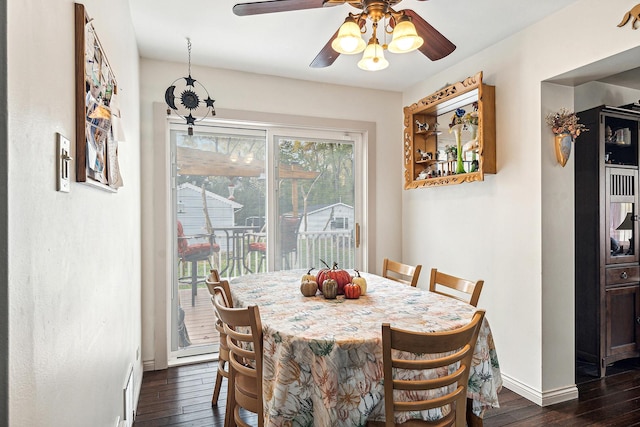 dining space featuring ceiling fan, dark wood-type flooring, and baseboards