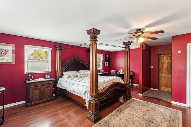 bedroom featuring a ceiling fan, baseboards, and wood finished floors