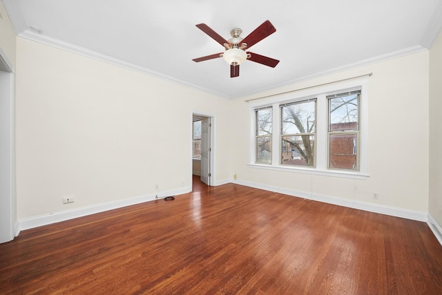 spare room featuring ceiling fan, ornamental molding, wood finished floors, and baseboards