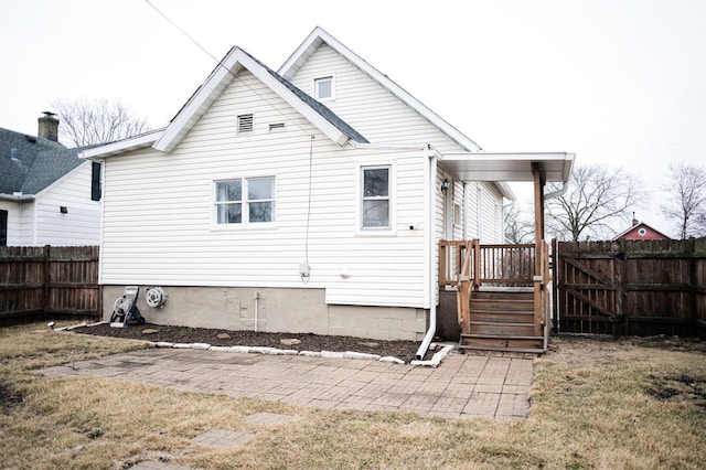 rear view of property with fence