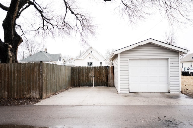 detached garage featuring fence