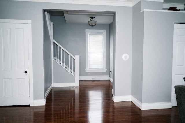 entryway featuring baseboards, stairway, and wood finished floors