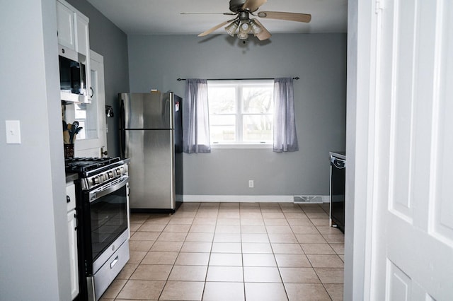 kitchen with light tile patterned floors, ceiling fan, white cabinetry, baseboards, and appliances with stainless steel finishes