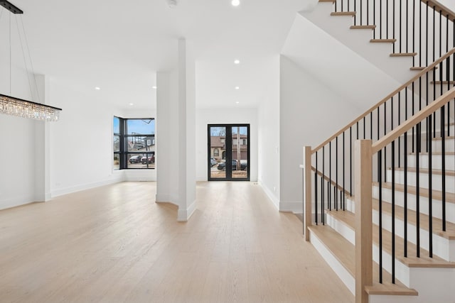 entryway featuring stairs, recessed lighting, baseboards, and light wood-style floors