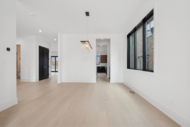 spare room with light wood-style flooring, visible vents, baseboards, and recessed lighting