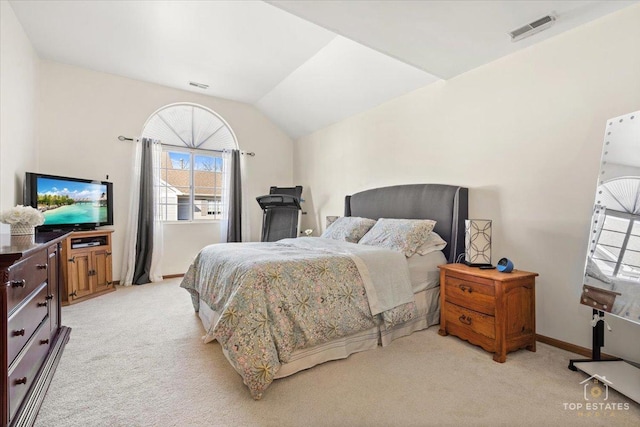 bedroom featuring visible vents, light carpet, and vaulted ceiling