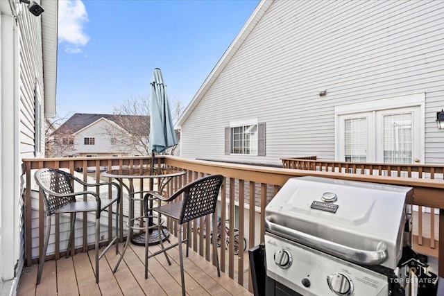 wooden terrace with a grill