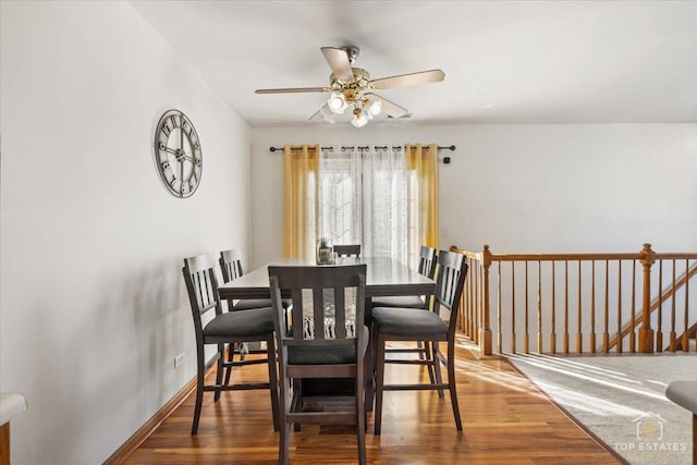 dining room with wood finished floors, baseboards, and ceiling fan