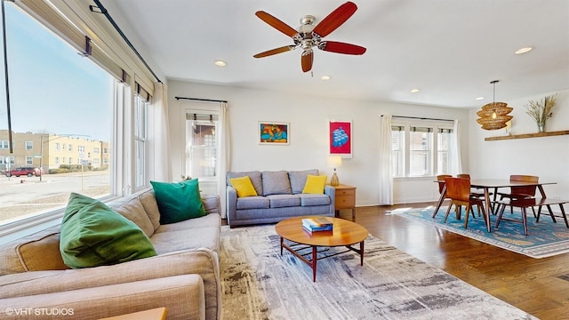 living room featuring recessed lighting, baseboards, wood finished floors, and ceiling fan