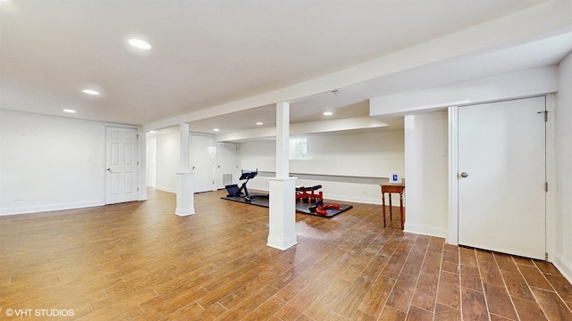 exercise room with recessed lighting, wood finished floors, and baseboards