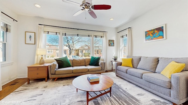 living area with wood finished floors, visible vents, baseboards, recessed lighting, and ceiling fan