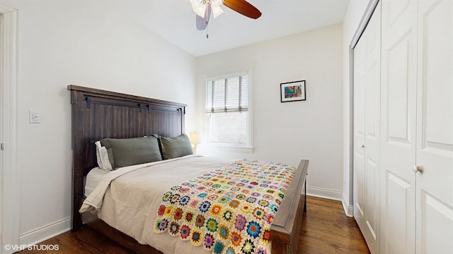 bedroom featuring a closet, a ceiling fan, dark wood-type flooring, and baseboards