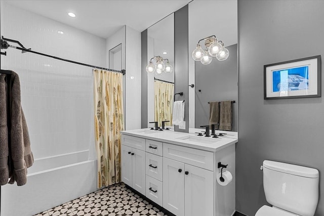 full bathroom featuring double vanity, toilet, shower / bath combo, a sink, and tile patterned floors