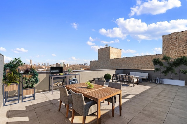 view of patio featuring outdoor dining area, area for grilling, and an outdoor hangout area