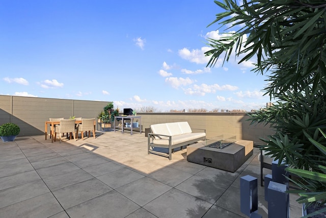 view of patio with an outdoor fire pit and outdoor dining area