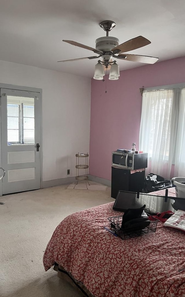 bedroom featuring ceiling fan, carpet flooring, and baseboards