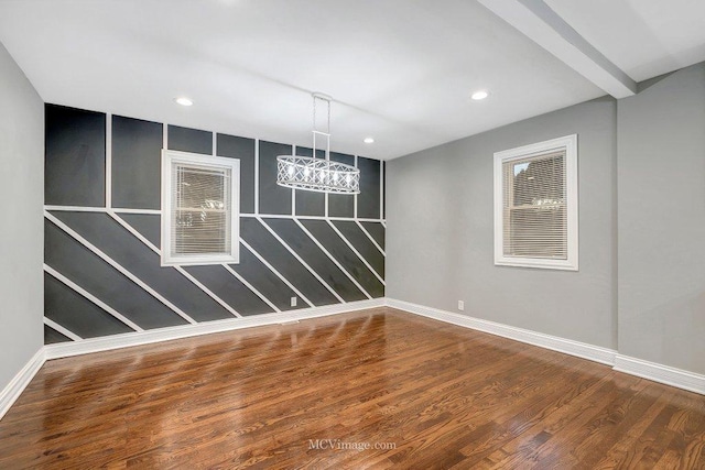 unfurnished dining area with beam ceiling, baseboards, wood finished floors, and recessed lighting