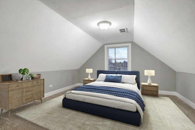 carpeted bedroom featuring vaulted ceiling, visible vents, and baseboards