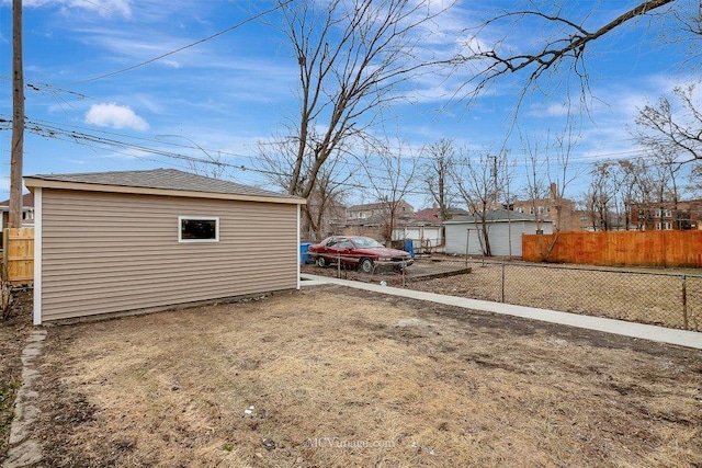 view of yard featuring fence and an outdoor structure