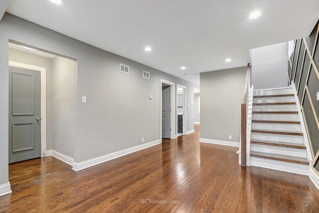 interior space featuring recessed lighting, visible vents, stairway, wood finished floors, and baseboards