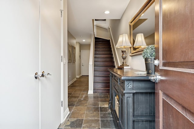 interior space with vanity, recessed lighting, baseboards, and stone finish flooring