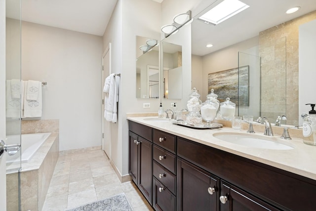 full bathroom featuring a bath, a tile shower, double vanity, and a sink