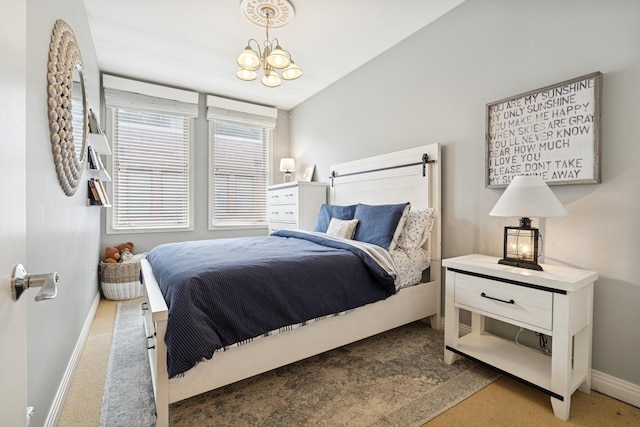 bedroom with carpet, baseboards, and a chandelier