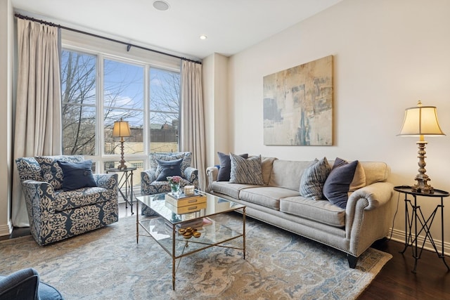 living area with recessed lighting, baseboards, and wood finished floors