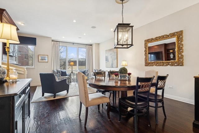 dining space with a wealth of natural light, recessed lighting, dark wood-type flooring, and baseboards