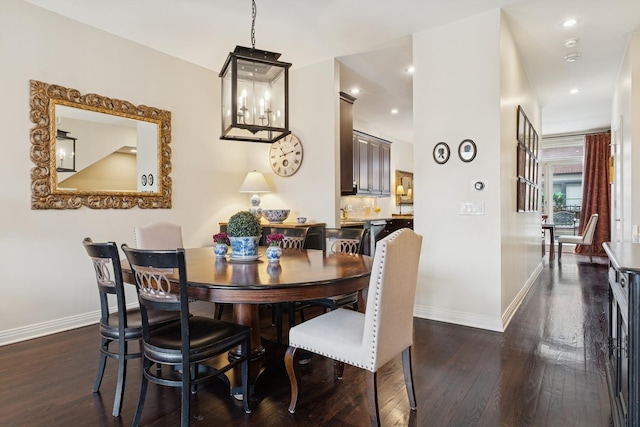 dining space with recessed lighting, baseboards, and dark wood-style flooring