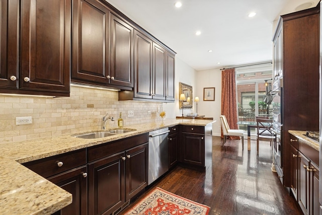 kitchen featuring backsplash, dark wood-type flooring, light stone counters, stainless steel dishwasher, and a sink