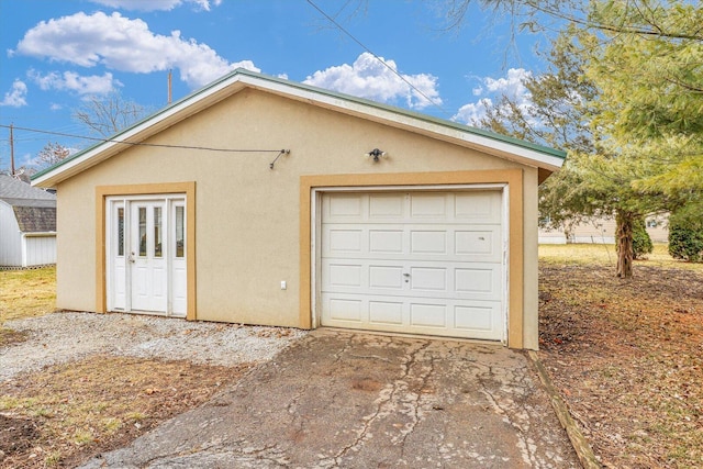 detached garage with concrete driveway