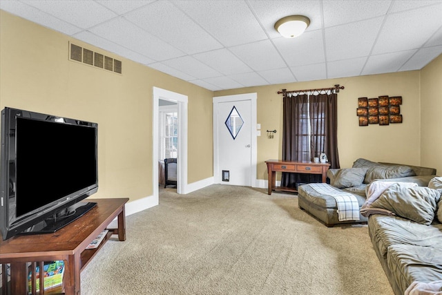 living room with carpet floors, a drop ceiling, visible vents, and baseboards