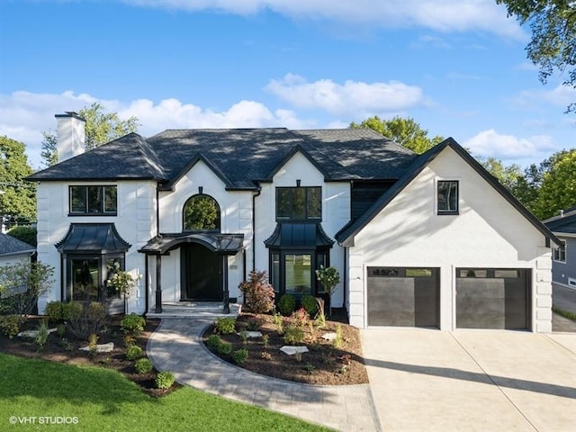 view of front of home featuring metal roof, driveway, and a standing seam roof