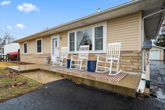 rear view of property with stone siding