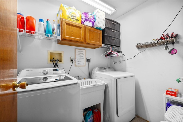 laundry area featuring cabinet space and washer and clothes dryer