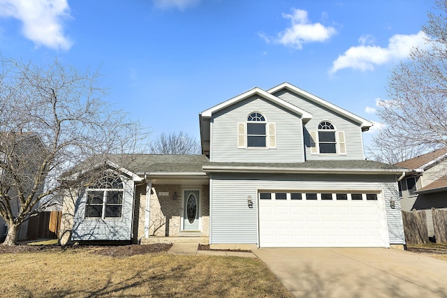 traditional-style house with an attached garage, driveway, roof with shingles, and fence