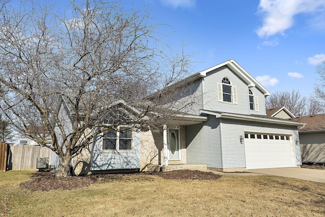 traditional-style home with a garage, a front yard, driveway, and fence