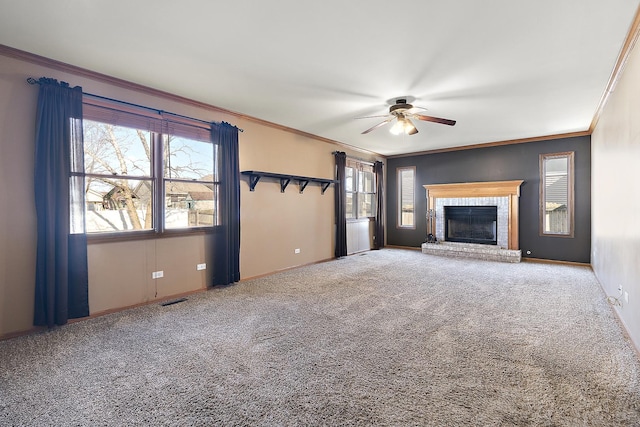 unfurnished living room featuring ornamental molding, carpet flooring, visible vents, and ceiling fan