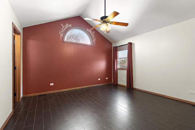 unfurnished room featuring dark wood-type flooring, a healthy amount of sunlight, ceiling fan, and vaulted ceiling