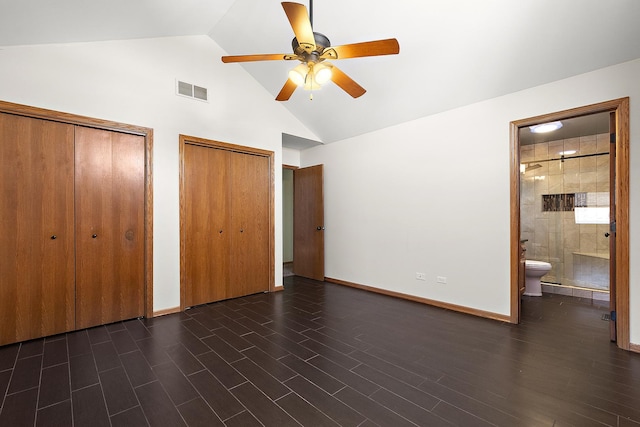 unfurnished bedroom with visible vents, two closets, baseboards, ensuite bathroom, and dark wood-style floors