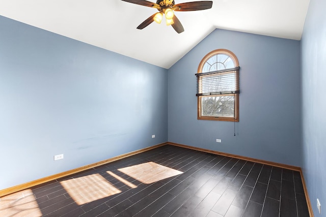 spare room with baseboards, wood finished floors, ceiling fan, and vaulted ceiling