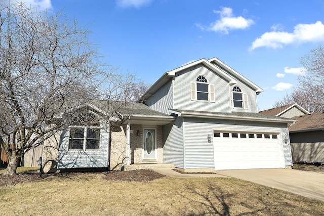 traditional-style house featuring a front yard, concrete driveway, and an attached garage